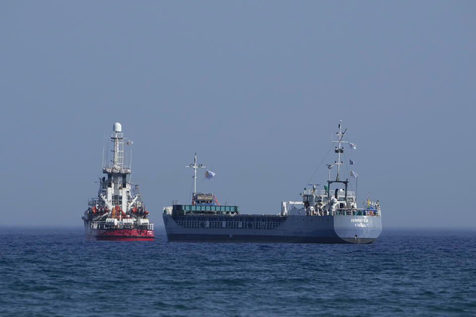 FILE - A cargo ship, right, and a ship belonging to the Open Arms aid group, are loaded with 240 tons of canned food destined for Gaza prepare to set sail outside the Cypriot port of Larnaca, Cyprus, on March 30, 2024. World Central Kitchen, the food charity founded by celebrity chef José Andrés, called a halt to its work in the Gaza Strip after an apparent Israeli strike killed seven of its workers, mostly foreigners. (AP Photo/Petros Karadjias, File)