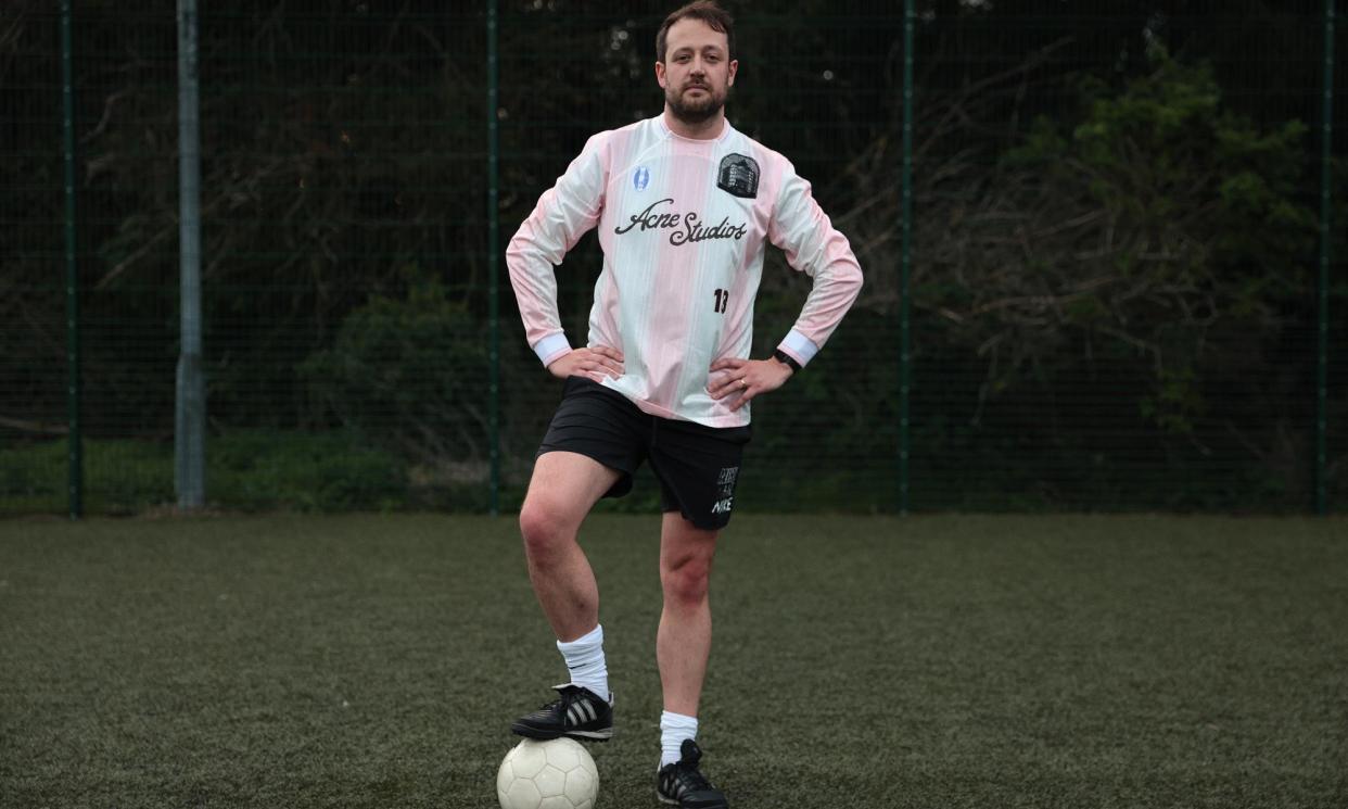 <span>Will Dean modelling Acne’s ‘appliquéd logo-print striped mesh T-shirt’.</span><span>Photograph: Martin Godwin/The Guardian</span>