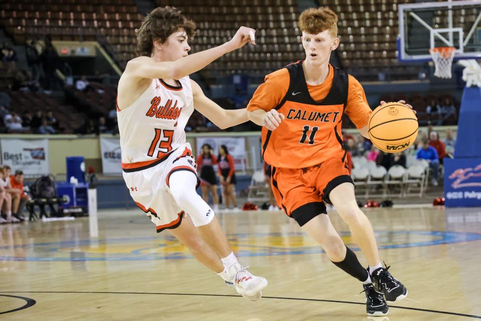 Calumet’s Kyler Thiessen (11) works past Sentinel’s Mavrick Sanders (13) during the Class B boys quarterfinal game between Calumet Chieftains and Sentinel Bulldogs at State Fair Arena in Oklahoma City on Thursday, March 2, 2023.