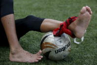 An injured member of Malaysia's under-13 National Football Development Programme sits out a training session in Kuala Lumpur, Malaysia, in this picture taken January 25, 2016. REUTERS/Olivia Harris