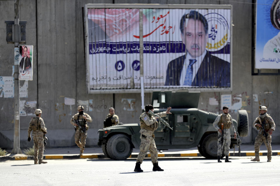 Afghan security forces work at the site of a suicide attack near the U.S. Embassy in Kabul, Afghanistan, Tuesday, Sept. 17, 2019. Hours earlier Afghan officials said a suicide bomber rammed his motorcycle packed with explosives into the entrance to a campaign rally of President Ashraf Ghani in northern Parwan province, killing over 20 people and wounding over 30. Ghani was present at the venue but was unharmed. The Taliban have claimed both attacks. (AP Photo/Ebrahim Noroozi)