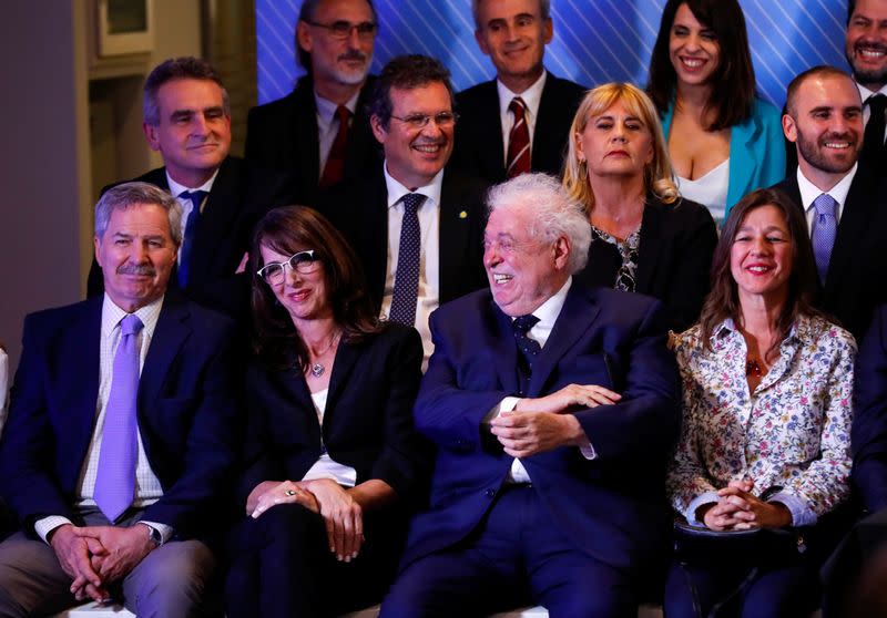 Argentina's incoming Health Minister, Gines Gonzalez Sola laughs as Argentina's President-elect Alberto Fernandez announces his cabinet, ahead of taking office, in Buenos Aires