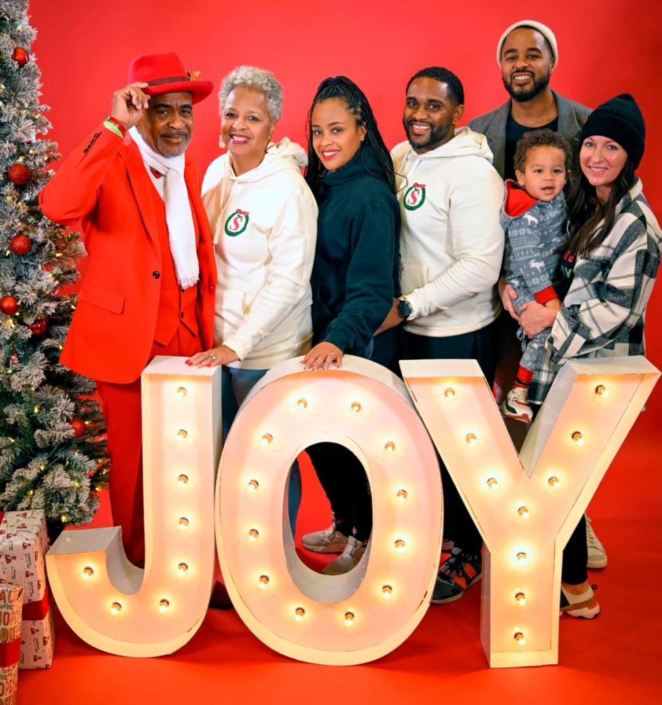 Tucker Lott, left, posed for a portrait with his family at the Soul of Santa breakfast. Lott, who portrays the Black Santa, is the founder of the Soul of Santa Do Good Foundation, which has partnered with The Star to do family portraits for the last two years.