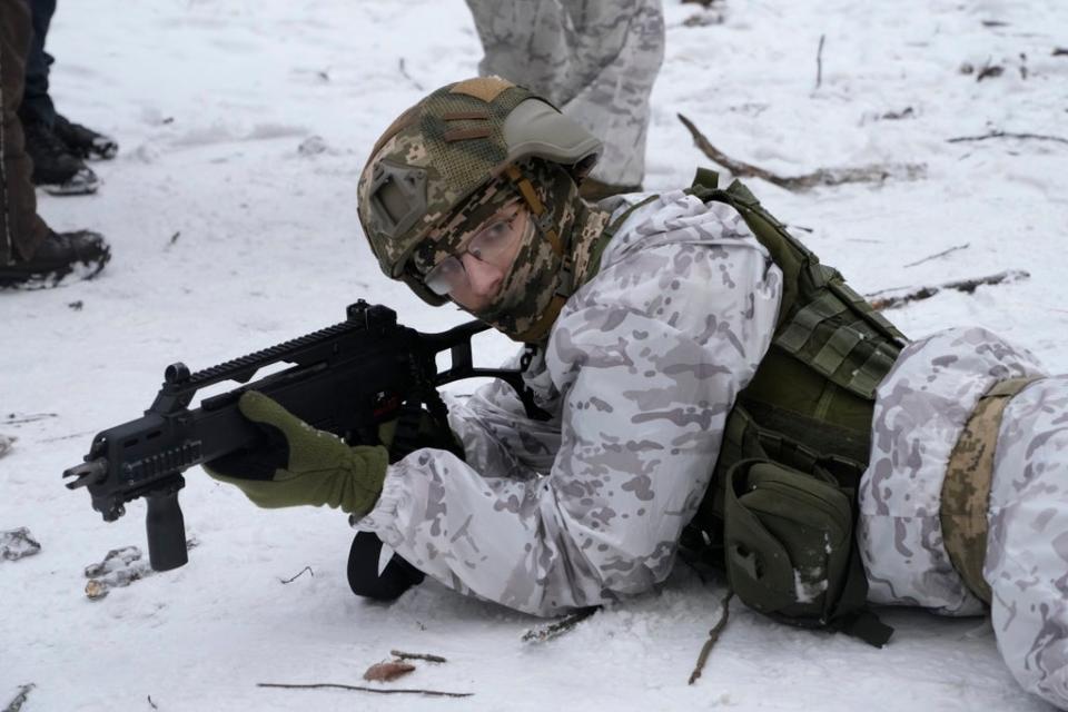 A member of Ukraine’s Territorial Defence Forces prepares for a potential Russian invasion (Efrem Lukatsky/AP) (AP)