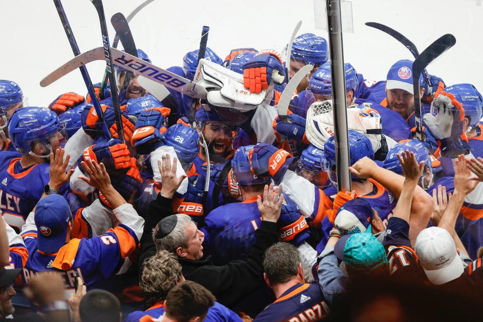 The New York Islanders celebrate after their 3-2 overtime victory against the Tampa Bay Lightning in Game Six of the 2021 Stanley Cup Semifinals.