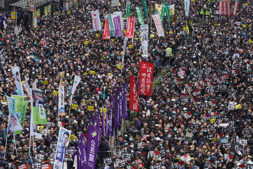 Hong Kong people participate in their annual pro-democracy march to insist their five demands be matched by the government in Hong Kong, Wednesday, Jan. 1, 2020. The five demands include democratic elections for Hong Kong's leader and legislature and a demand for a probe of police behavior during the six months of continuous protests. (AP Photo/Vincent Yu)