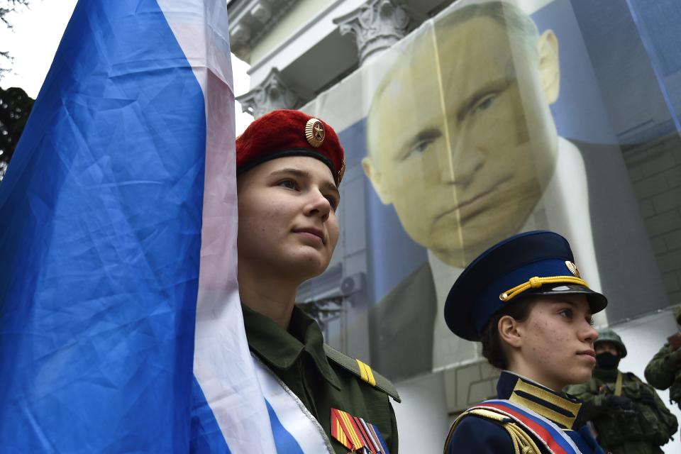 Youth take part in an action to mark the ninth anniversary of the Crimea annexation from Ukraine in Yalta, Crimea, Friday, March 17, 2023. (AP Photo)
