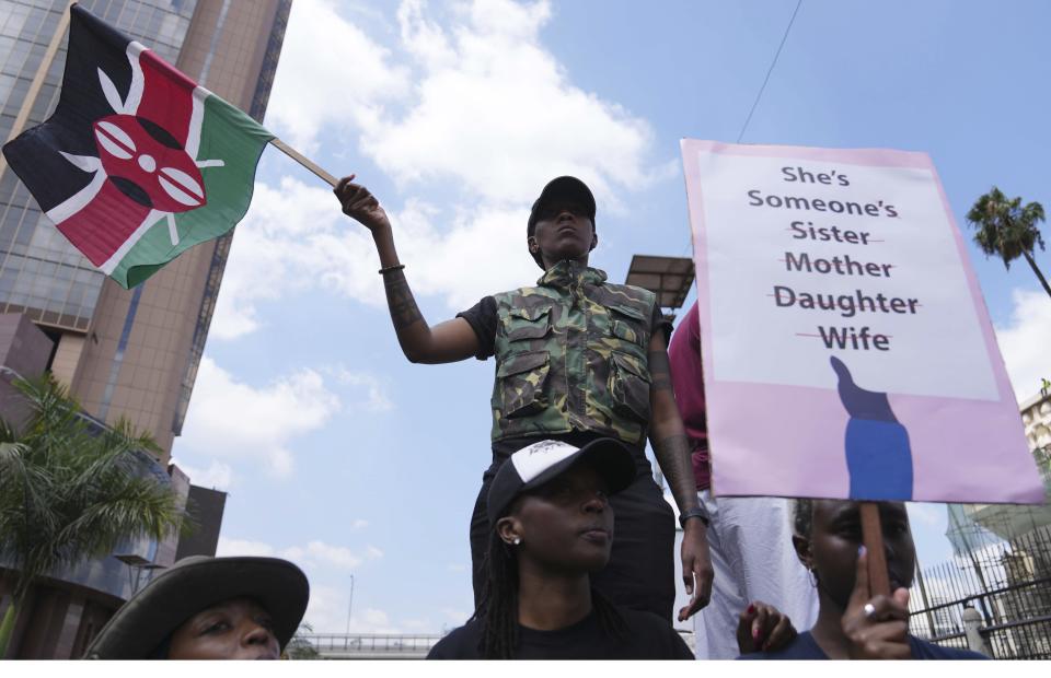 A protester holds a Kenyan flag during a procession to protest against the rising cases of femicide, in downtown Nairobi, Kenya Saturday, Jan. 27, 2024. Thousands of people marched in cities and towns in Kenya during protests Saturday over the recent slayings of more than a dozen women. The anti-femicide demonstration was the largest event ever held in the country against sexual and gender-based violence. (AP Photo/Brian Inganga)