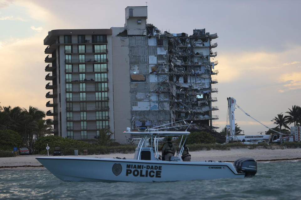 SURFSIDE, FLORIDA - JULY 04: A police boat passes off shore of the partially collapsed 12-story Champlain Towers South condo building before a controlled demolition on July 4, 2021 in Surfside, Florida. The decision by officials to bring the rest of the building down was brought on by the approach of Tropical Storm Elsa and fears that the structure might come down in an uncontrolled fashion. Over one hundred people are missing as the search-and-rescue effort continues. (Photo by Joe Raedle/Getty Images)
