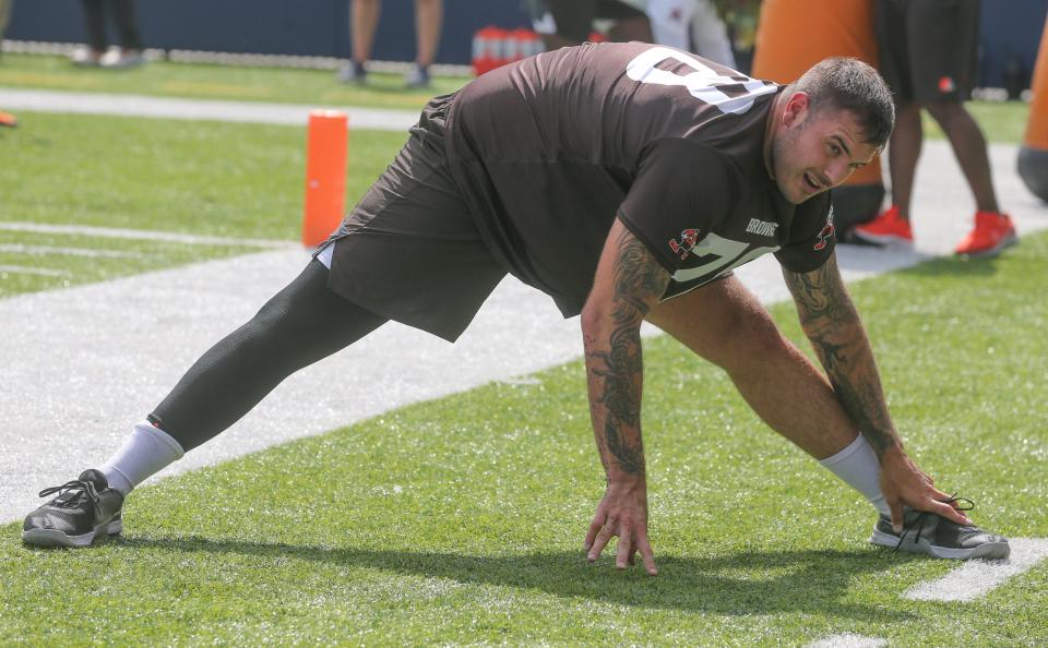 Cleveland Browns offensive lineman Jack Conklin stretches before minicamp on Wednesday, June 15, 2022 in Canton, Ohio, at Tom Benson Hall of Fame Stadium.