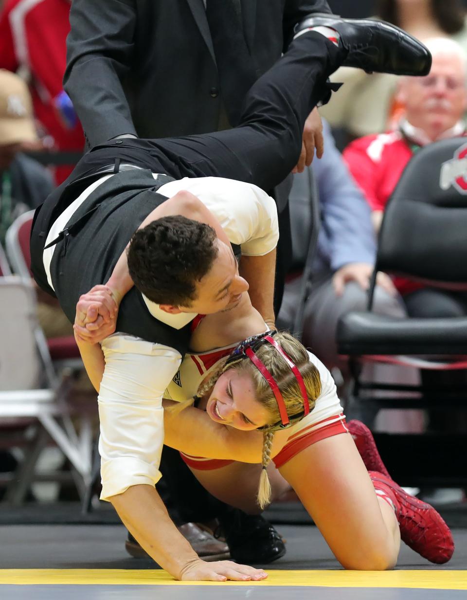 Jaydyn McKinney tosses her coach to the mat after winning the 135 girls championship match in the OHSAA State Wrestling Tournament at the Jerome Schottenstein Center, Sunday, March 12, 2023, in Columbus, Ohio.
