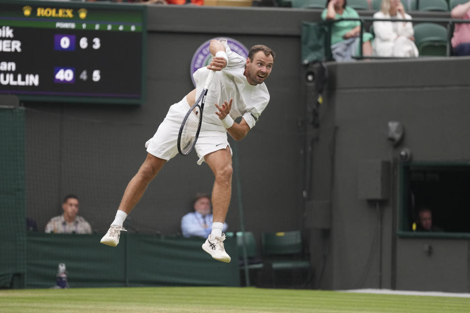 Russia's Roman Safiullin in action against Italy's Jannik Sinner during their men's singles match on day nine of the Wimbledon tennis championships in London, Tuesday, July 11, 2023. (AP Photo/Alberto Pezzali)