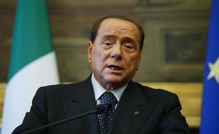 Leader of Forza Italia party Silvio Berlusconi talks to reporters at the end of the consultations with Italian Prime Minister-designate Matteo Renzi (not seen) at the Parliament in Rome February 19, 2014. REUTERS/Tony Gentile