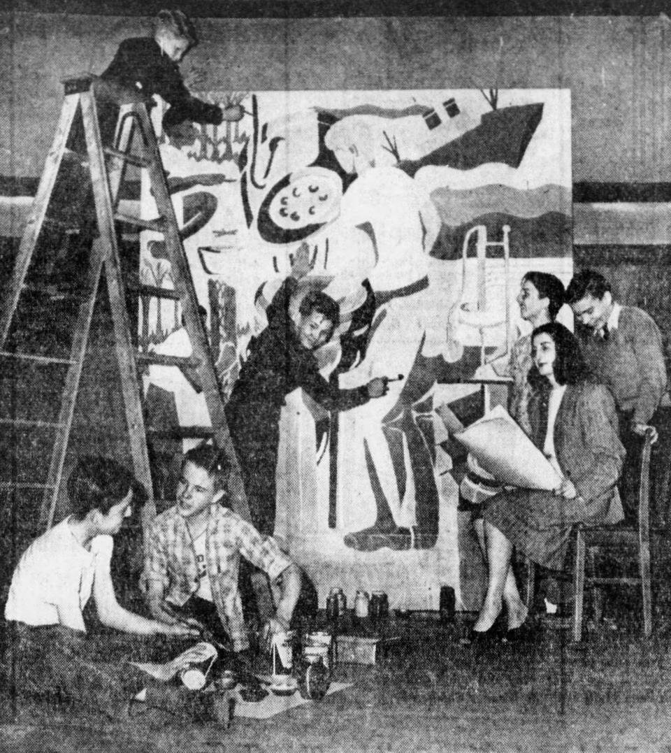 Art teacher Virginia Goson supervises as Lawndale Elementary School seventh graders put the finishing touches on an Akron mural in May 1947. In the foreground are Guy Thrams and David Robinson. In the background are, from left, John Reffner, Donald Holliday, James Dorton and Hubert Schaneman.