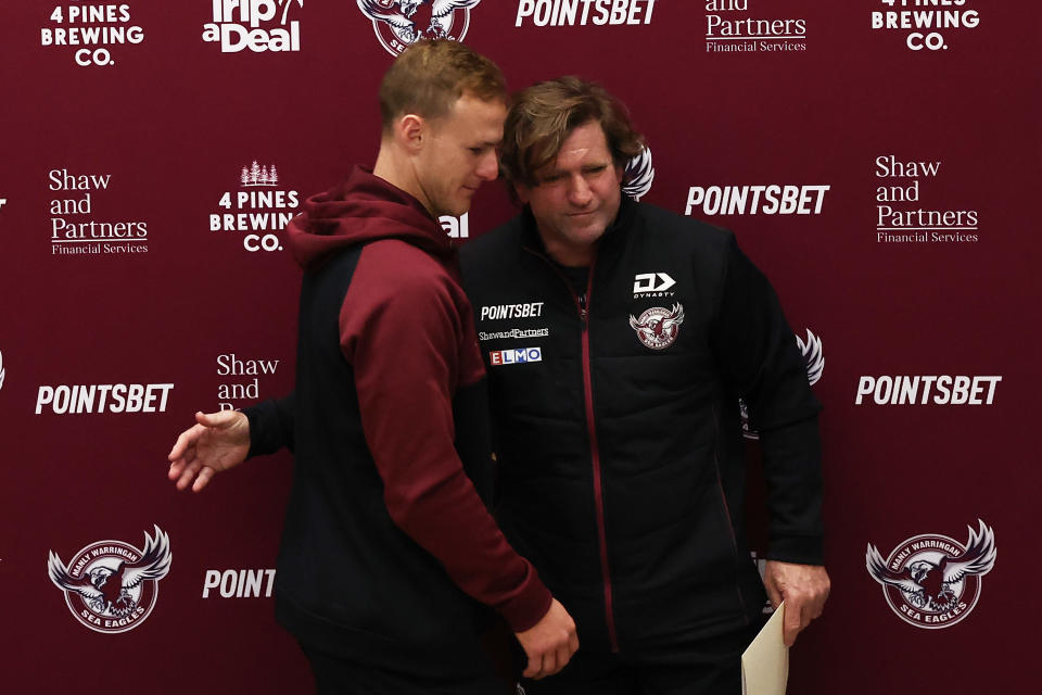 Pictured left to right, Manly captain Daly Cherry-Evans and coach Des Hasler embrace at a press conference.