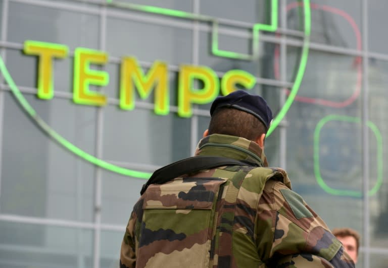 A French soldier patrols in the La Defense business district near Paris on November 25, 2015, as France's military sees a spike in interest from potential recruits in the wake of the November 13 jihadist attacks on Paris