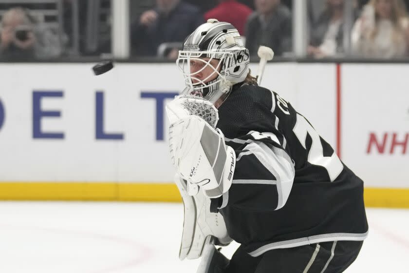 Kings goaltender Pheonix Copley crouches in front of goal and watches the puck