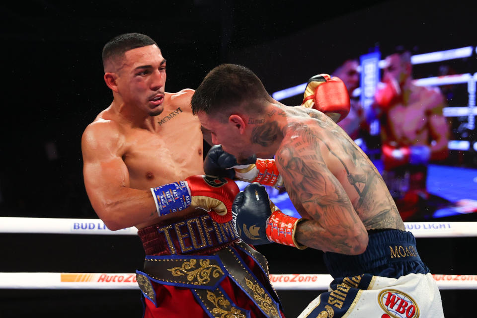 Pictured right, George Kambosos Jr punches Teofimo Lopez during their lightweight title fight in New York. 