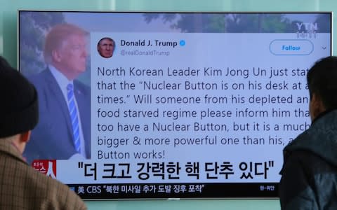People watch a TV news program showing the Twitter post of U.S. President Donald Trump while reporting North Korea's nuclear issue, at Seoul Railway Station in Seoul, South Korea - Credit: AP Photo/Ahn Young-joon