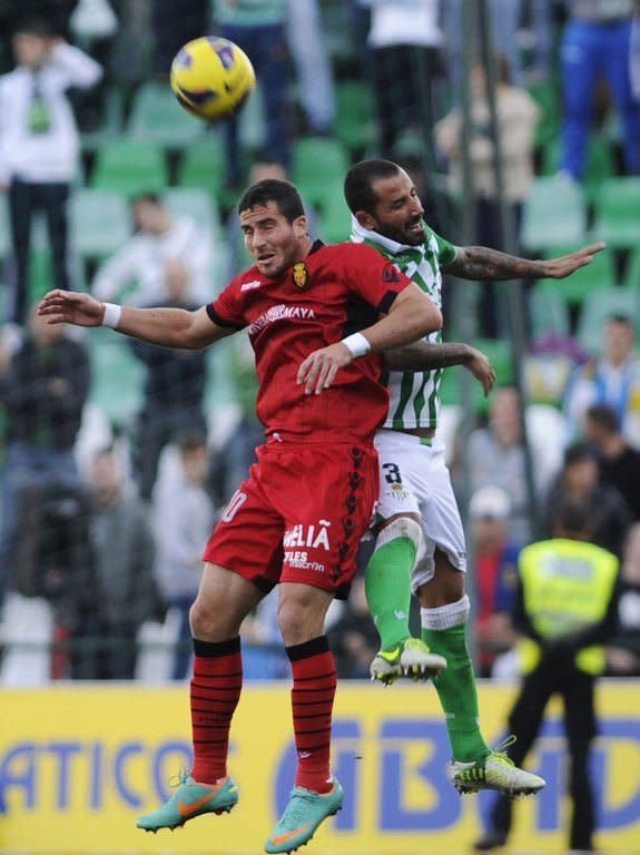 Mallorca's forward Tomer Hemed (L) jumps with Betis' defender Mario during the Spanish league football match at the Benito Villamarin stadium in Sevilla on December 22, 2012. Mallorca surprised an in-form Real Betis with a 2-1 away win that denied the side from Seville a chance to move into fourth position