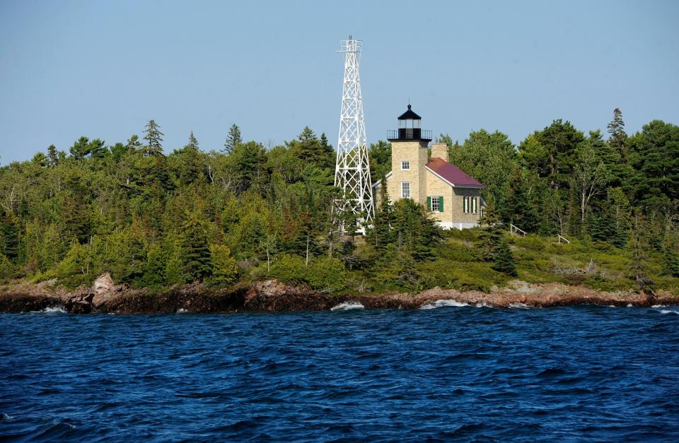 Lake Superior's waves crash as the Copper Harbor Lighthouse greets visitors returning from Isle Royale National Park at the north end of Lake Superior.