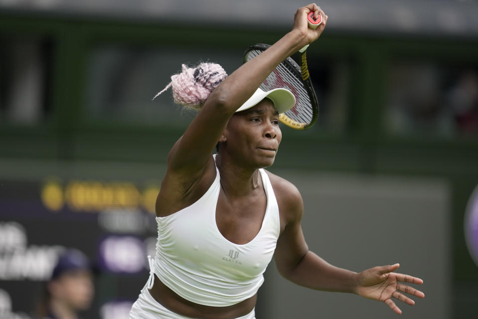 Venus Williams of the US returns to Ukraine's Elina Svitolina in a first round women's singles match on day one of the Wimbledon tennis championships in London, Monday, July 3, 2023. (AP Photo/Kin Cheung)