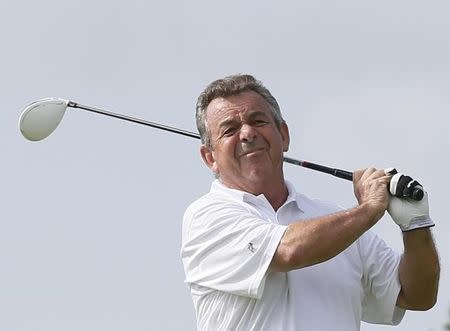 Tony Jacklin of England tees off on the first hole during the first round of the Mission Hills World Celebrity Pro-Am golf tournament in Haikou, China's Hainan province October 20, 2012. REUTERS/Tyrone Siu/Files