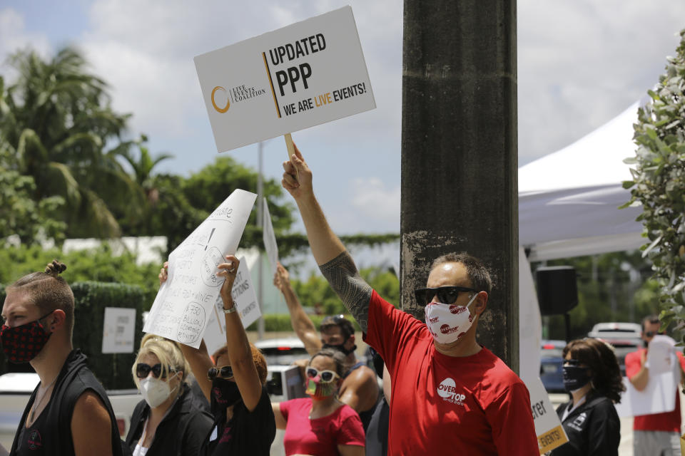 Rob Glassman, general manager of the Over the Top rental linens company, protests in support of the live events industry receiving federal aid outside of the office of Sen. Marco Rubio, R-Fla., during the coronavirus pandemic, Thursday, July 30, 2020, in Miami. Many small businesses in the events industry have been shut down since March due to the pandemic. (AP Photo/Lynne Sladky)