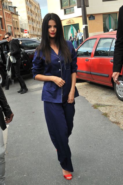 Selena Gomez rocked a surprising new fashion trend in Paris on Saturday. Sporting straight hair and ruby red lipstick, the "Same Old Love" singer stepped out in navy blue pajamas and red high heels to promote her upcoming album, <em>Revival</em>, at a recording studio in the French capital. INFphoto.com <strong> WATCH: Selena Gomez Praises Ex-Boyfriend Justin Bieber's Comeback</strong> Aside from this interesting casual-meets-glam look, Gomez's fashion game has been on point lately. Dressed in a gorgeous white flowy wrap dress with a gold-studded belt, Gomez looked like she was reliving her royal <em>Monte Carlo</em> days when she stepped out Saturday evening. Gomez played the lead role of Grace, a young girl who is mistaken as a British heiress, in the 2012 film about three best friends vacationing and having the time of their lives in Paris. SPL_Paris Before jetting to France, the former Disney star was promoting her second solo album, which drops Oct. 9, in London. She took to Instagram to share a photo in another fashionable outfit, a custom Atea Oceanie slip dress, which she wore to an interview on the <em>Alan Carr: Chatty Man </em>talk show. The outfit is similar to the look Aniston rocked at the 2002 Emmy Awards -- and Gomez was pretty stoked about that. "I won't post a lot of pics like this but I have to say this was one of my favorites! Made me feel like Jennifer Aniston. LOVE YOU @ateaoceanie," the 23-year-old singer-actress wrote. This isn't the first time Gomez has gushed about the 46-year-old former <em>Friends </em>star. "She's amazing," Gomez said during a radio interview with KTU's Carolina Bermudez in June. "We met through my [old] management … so it was kind of like a friendly meeting and instantly she's, like, inviting me to her house. She has a pizza oven. Like, we've made pizzas at her house. She's very cool and very sweet. She kind of gives me a lot of, like, maternal advice." <strong> WATCH: Selena Gomez Stuns in a Sexy, High-Cut Swimsuit</strong> While on the U.K. talk show, Carr offered Gomez a drink of choice, pouring each other a shot of Fireball Cinnamon Whisky to take together. "I’m from Texas, so...." the singer said. After filming, Gomez tweeted, "LOVE you @chattyman –drinks and fun." LOVE you @chattyman -drinks and fun https://t.co/JGXx9L7Qgg— Selena Gomez (@selenagomez) September 25, 2015 Carr also took to Twitter, writing, "Anyone else for a glass of Fireball?" He also shared a series of pics with the Texas-born singer. Loving the alternative #GoodForYou! @selenagomez v @alancarr! Haha! #chattyman pic.twitter.com/fAERRrHpP5— Alan Carr Chatty Man (@chattyman) September 25, 2015 Wow – what a performance from @selenagomez! Totes getting #GoodForYou! :) Sam x #chattyman pic.twitter.com/8diKbDxMwA— Alan Carr Chatty Man (@chattyman) September 25, 2015 ET caught up with Gomez at New York Fashion Week in New York City, where she opened up about another one of her friends, Demi Lovato. Watch the video below to hear her talk about their rekindled friendship.