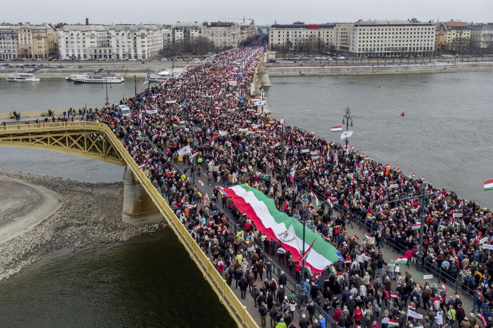 People cross Margaret Bridge as they participate in the Peace March, a demonstration organized by the pro-government Civic Solidarity Forum Foundation to express support for the current Hungarian government with regard to the upcoming general elections in April in Budapest, Hungary, Tuesday, March 2022, coinciding with the national holiday marking the 174th anniversary of the outbreak of the 1848 revolution and war of independence against the Habsburg rule. (Zsolt Czegledi/MTI via AP)