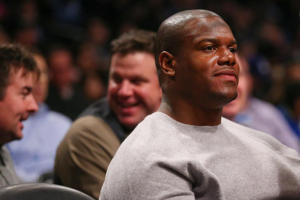 Former New York Jets star D'Brickashaw Ferguson sits courtside at a Brooklyn Nets NBA game in 2016.