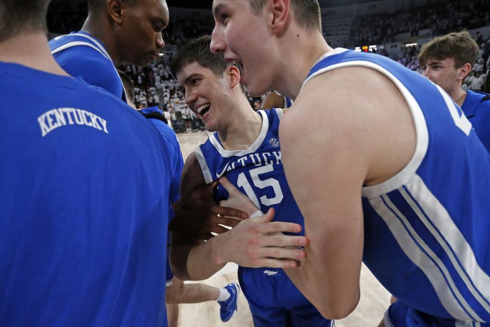 Kentucky's Ugonna Onyenso (33) and Zvonimir Ivišić (44) celebrate with Reed Sheppard after they helped defeat Mississippi State on Tuesday night.