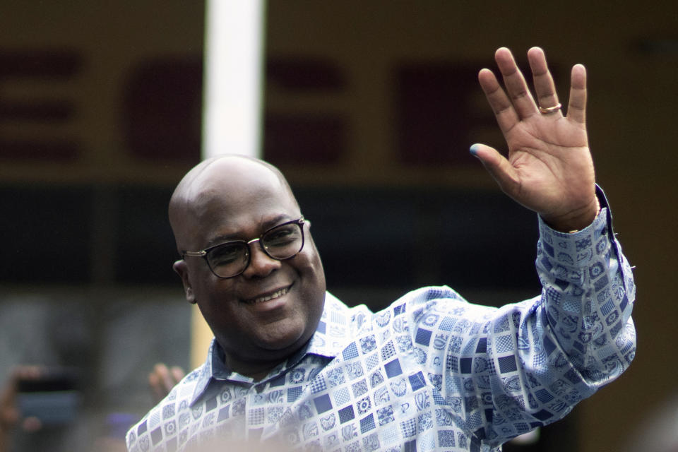 Congo's President Felix Tshisekedi waves to his supporters after casting his ballot inside a polling station during the presidential elections in Kinshasa, Democratic Republic of Congo, Wednesday, Dec. 20, 2023. Congo saw opening delays of up to seven hours in a presidential election Wednesday facing steep logistical and security challenges that raised questions about the credibility of the vote. (AP Photo/Mosa'ab Elshamy)