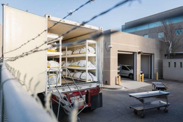 Bodies wrapped in plastic line the walls inside a refrigerated trailer used as a mobile morgue by the El Paso County Medical Examiner's office in El Paso, Texas on November 13, 2020. / Credit: JUSTIN HAMEL/AFP via Getty Images