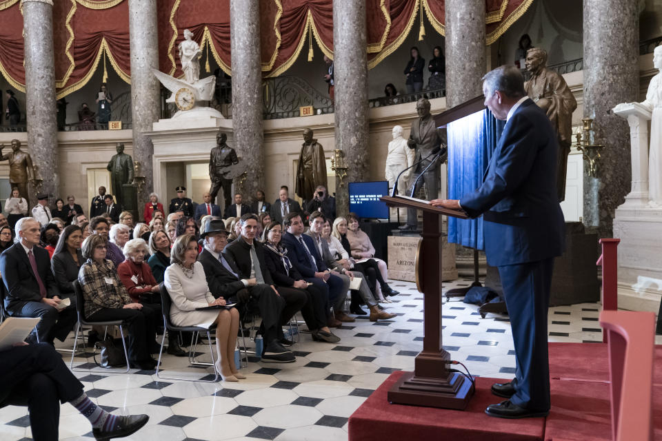 Speaker of the House Nancy Pelosi, D-Calif., seated at left, is joined by her husband Paul Pelosi as they listen to praise from former Republican Speaker John Boehner, right, during her portrait unveiling ceremony in Statuary Hall at the Capitol in Washington, Wednesday, Dec. 14, 2022. (AP Photo/J. Scott Applewhite)