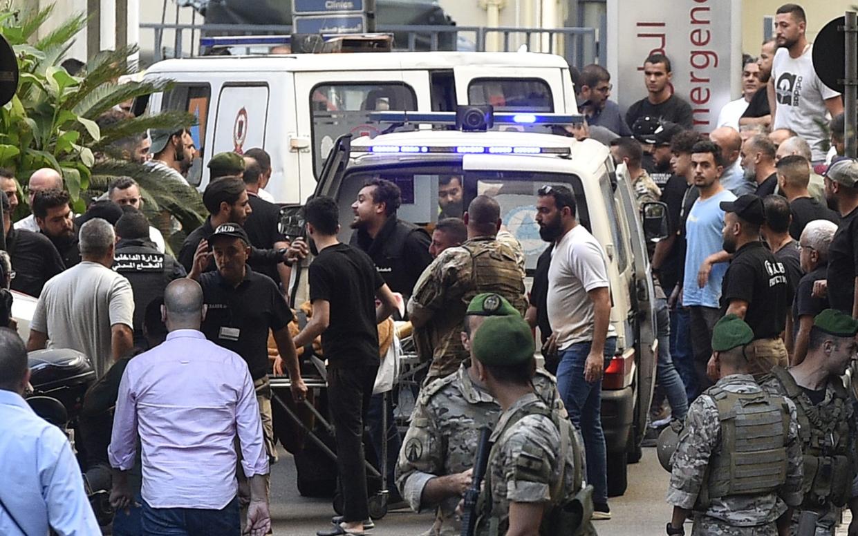 Paramedics transport an injured person to the American University of Beirut Medical Center