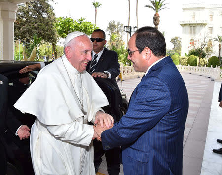 Egyptian President Abdel Fattah al-Sisi greets Pope Francis upon his arrival to Cairo, Egypt April 28, 2017 in this handout picture courtesy of the Egyptian Presidency. The Egyptian Presidency/Handout via REUTERS