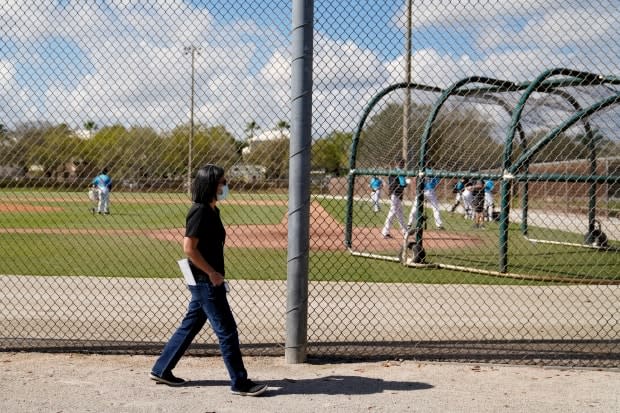 Miami Marlins general manager Kim Ng walks around a field during spring training practice in Jupiter, Fla., in February. 