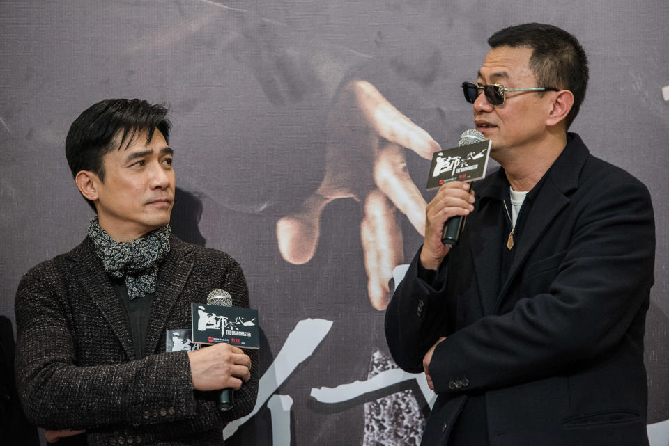 Hong Kong director Wong Kar Wai (R) speaks alongside Hong Kong actor Tony Leung during a press conference for his new film 