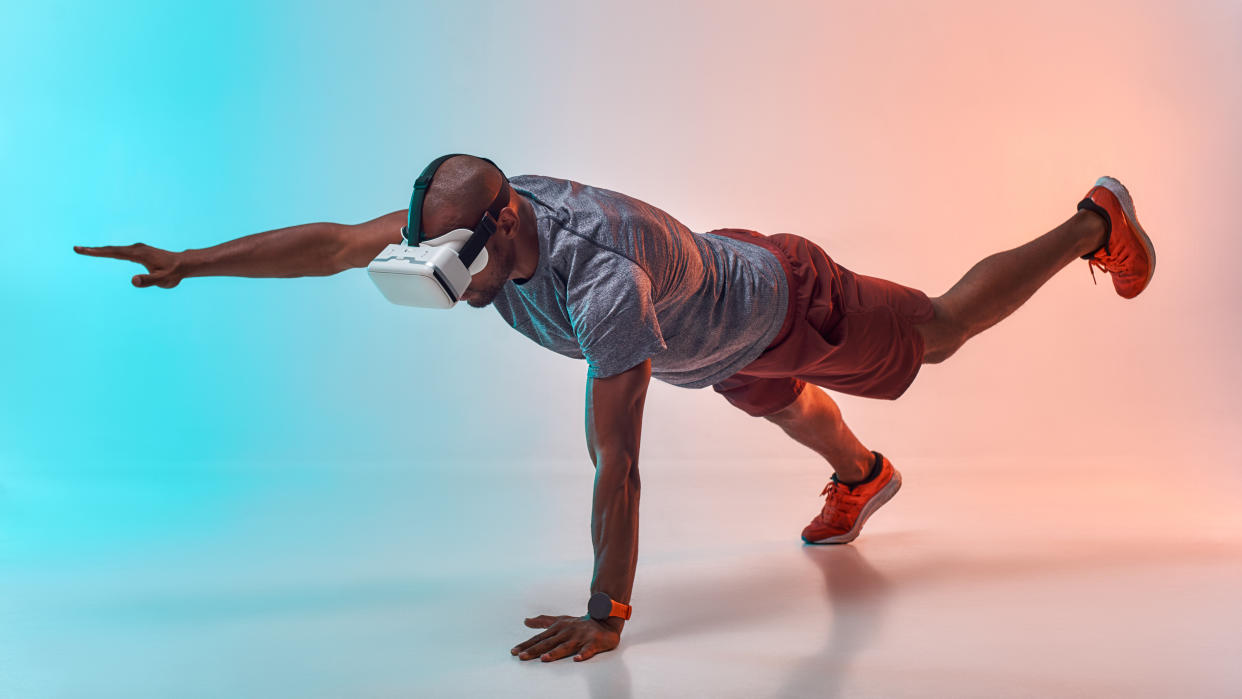   A VR user is working out while wearing a headset. 