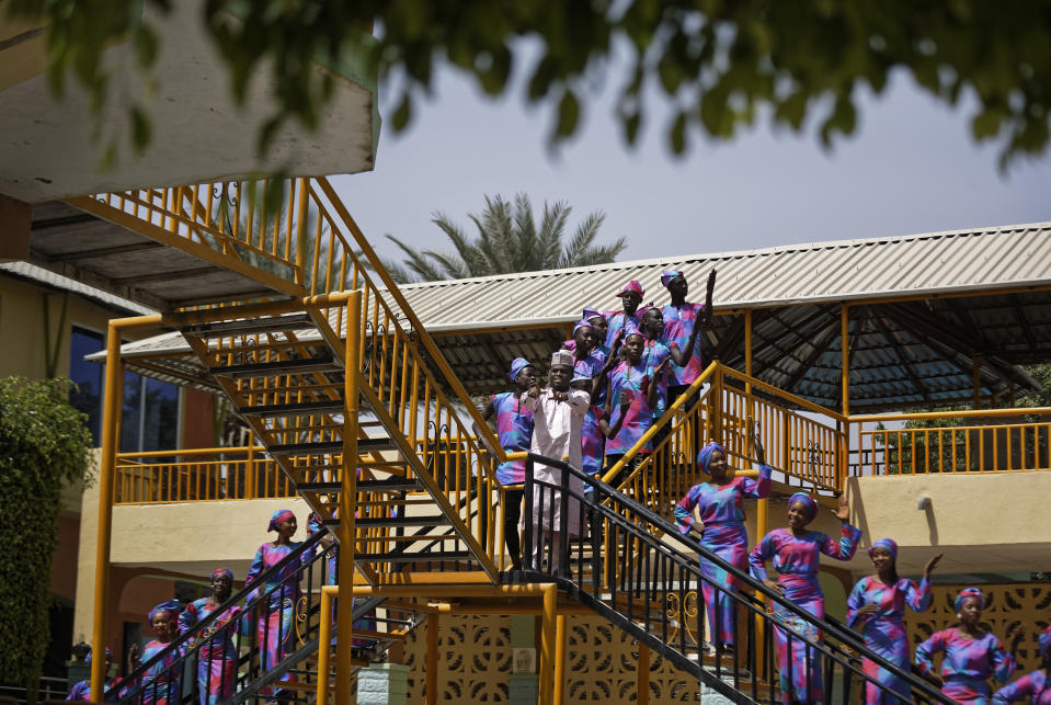 In this photo taken Monday, Feb. 18, 2019, performers record a music video calling for a peaceful election, at a golf resort outside of Kano, northern Nigeria. Faced with an election that could spiral into violence, some in the popular Hausa-language film industry known as Kannywood assembled this week to shoot an urgent music video appealing to the country for peace. (AP Photo/Ben Curtis)