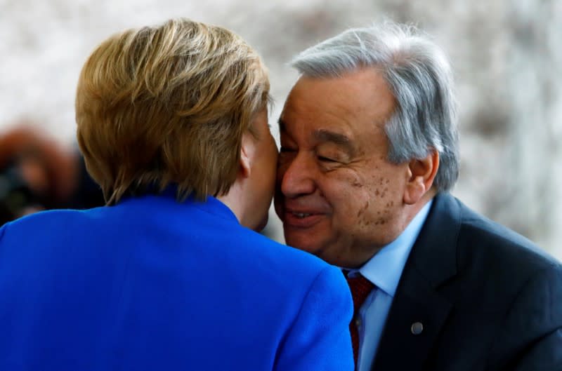 German Chancellor Angela Merkel welcomes United Nations Secretary-General Antonio Guterres at the Libya summit in Berlin