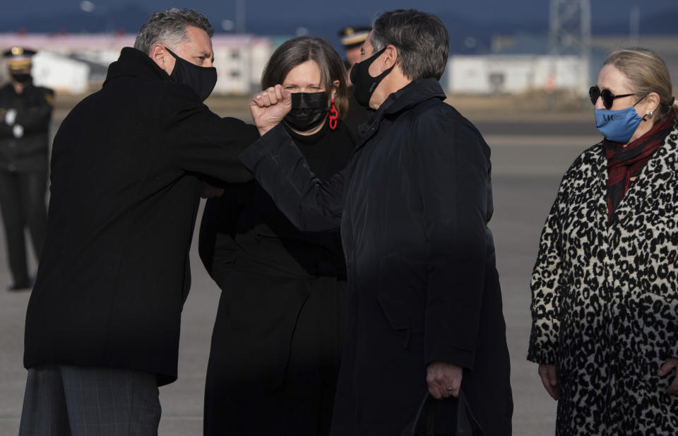 Charge d'Affaires of the US Embassy in Iceland Harry Kamian, left, greets US Secretary of State Antony Blinken, second from right, alongside Bergd's Ellertsd'ttir, Icelandic Ambassador to the United States, as Blinken disembarks from his airplane upon arrival at Keflavik Air Base in Iceland, May 17, 2021, his second stop on a 5-day European tour. (Saul Loeb/Pool Photo via AP)