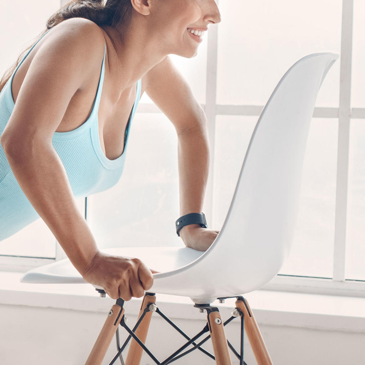 woman doing exercises with a chair
