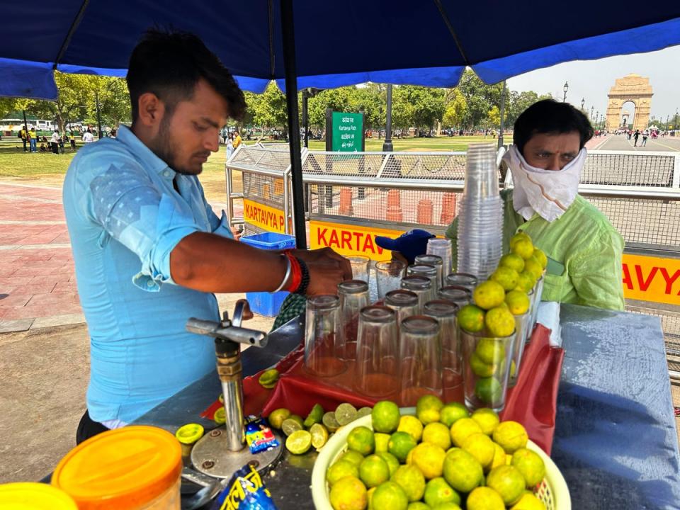 A roadside vendor sells iced lemonade in New Delhi (AP)