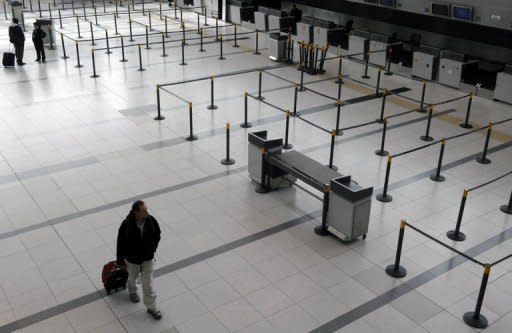 A man walks across the almost deserted hall of an international airport in Argentina after domestic and international flights at two airports in Buenos Aires were suspended due to volcanic ash from the eruption of the Puyehue volcano in Chile