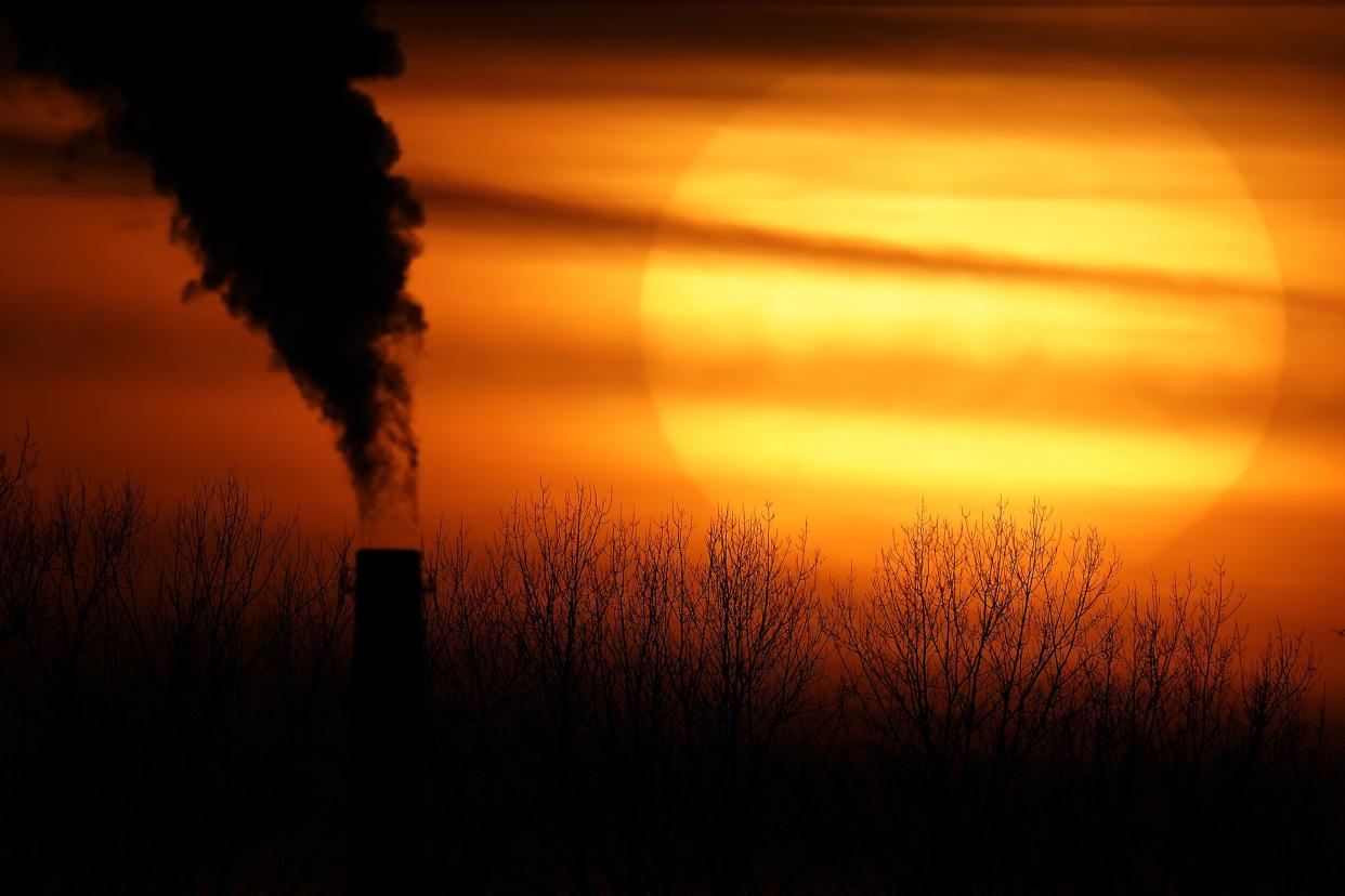 FILE - Emissions from a coal-fired power plant are silhouetted against the setting sun in Kansas City, Mo., Feb. 1, 2021. The Supreme Court on Thursday, June 30, 2022, limited how the nation’s main anti-air pollution law can be used to reduce carbon dioxide emissions from power plants. 