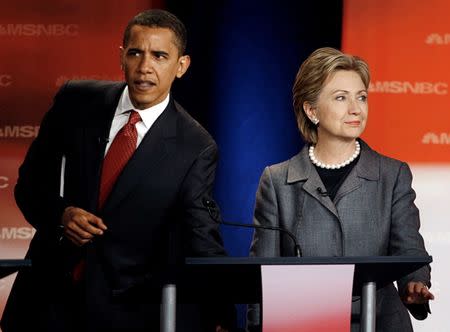 Barack Obama and Hillary Clinton wait before the South Carolina Democratic party's presidential candidates debate. REUTERS/Jim Bourg