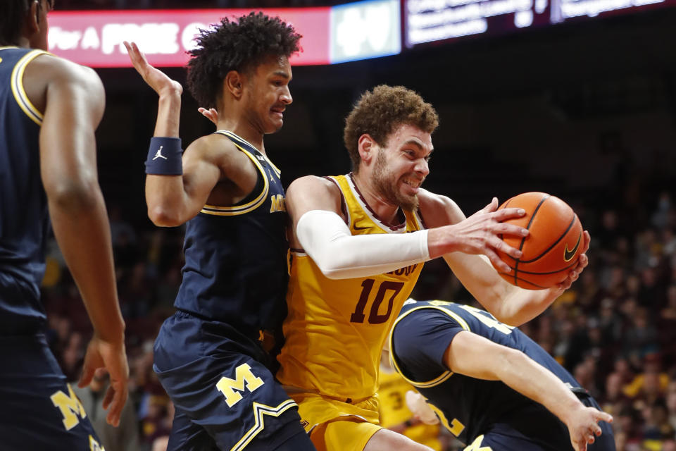 Minnesota forward Jamison Battle (10) works past Michigan guard Kobe Bufkin, left, during the first half of an NCAA college basketball game Thursday, Dec. 8, 2022, in Minneapolis. (AP Photo/Bruce Kluckhohn)