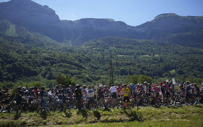 Bike riders wait for the 10th stage of the Tour de France to resume